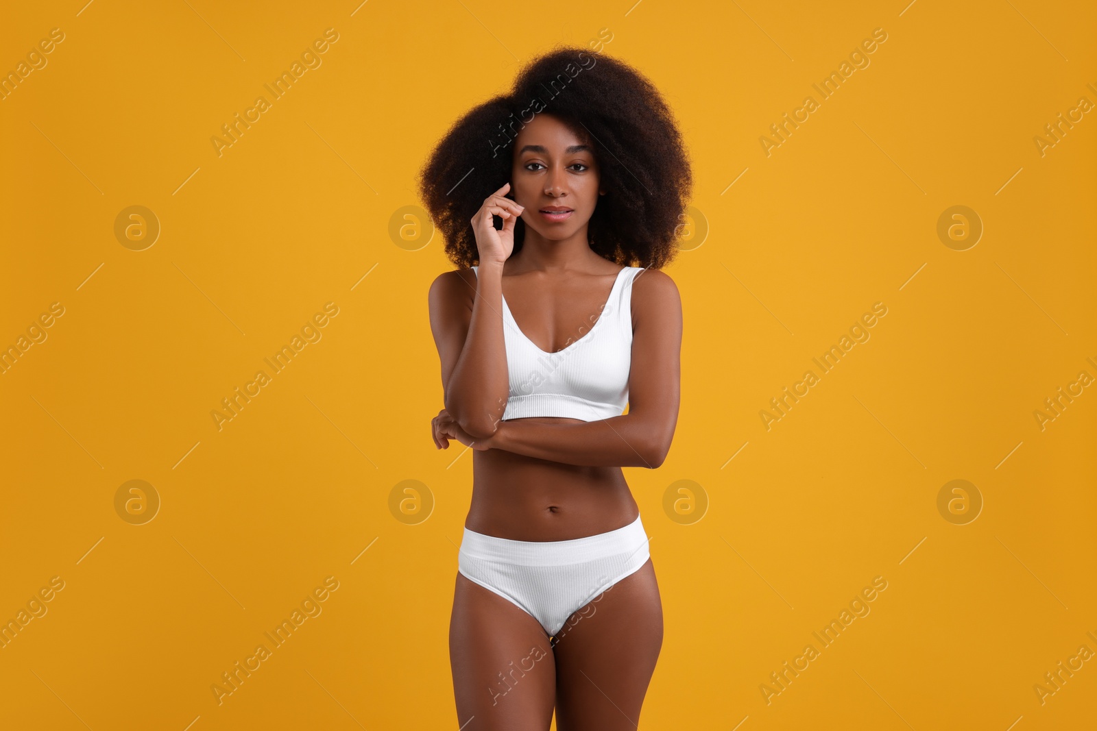 Photo of Beautiful woman in stylish bikini on yellow background