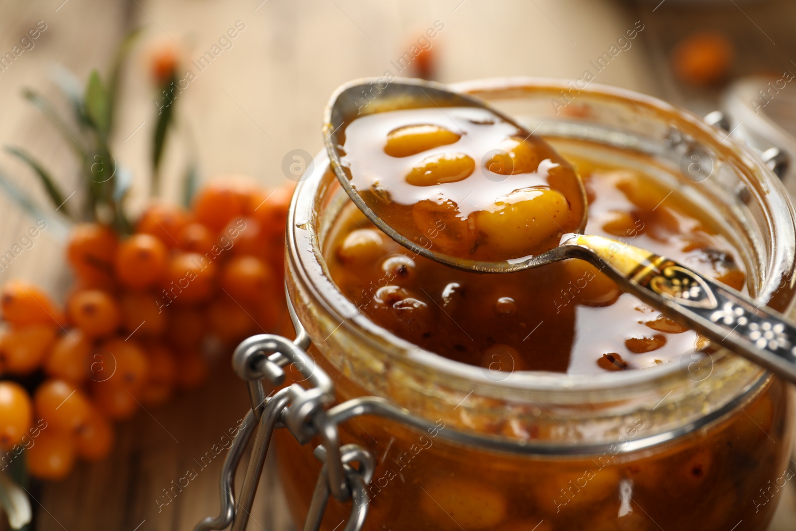 Photo of Delicious sea buckthorn jam in jar, closeup