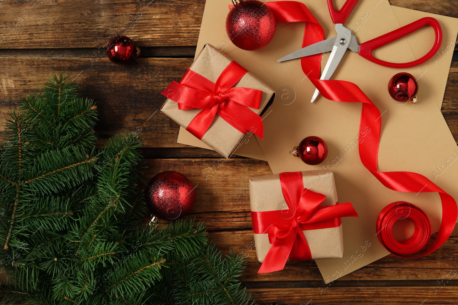 Photo of Flat lay composition with Christmas gift boxes and decor on wooden table