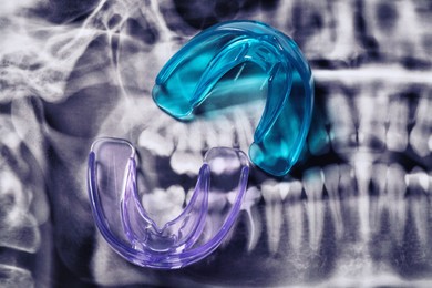 Photo of Mouth guards on dental scan, flat lay. Bite correction