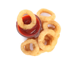 Delicious golden onion rings with ketchup isolated on white, top view