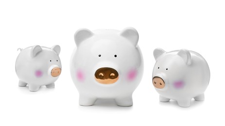 Image of Cute ceramic piggy banks on white background