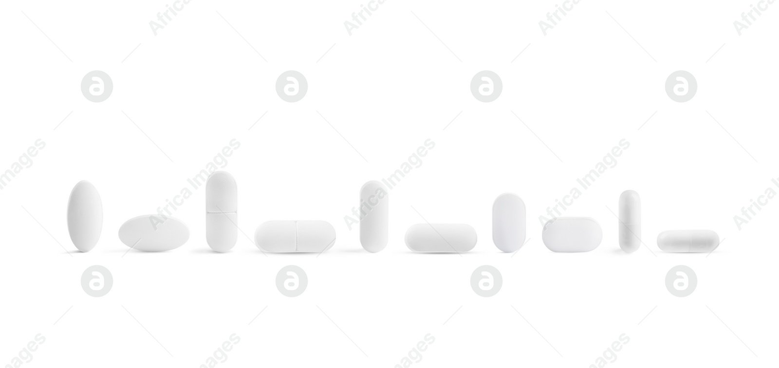 Image of Set of different pills in row isolated on white