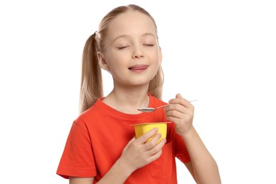 Photo of Cute little girl enjoying tasty yogurt on white background