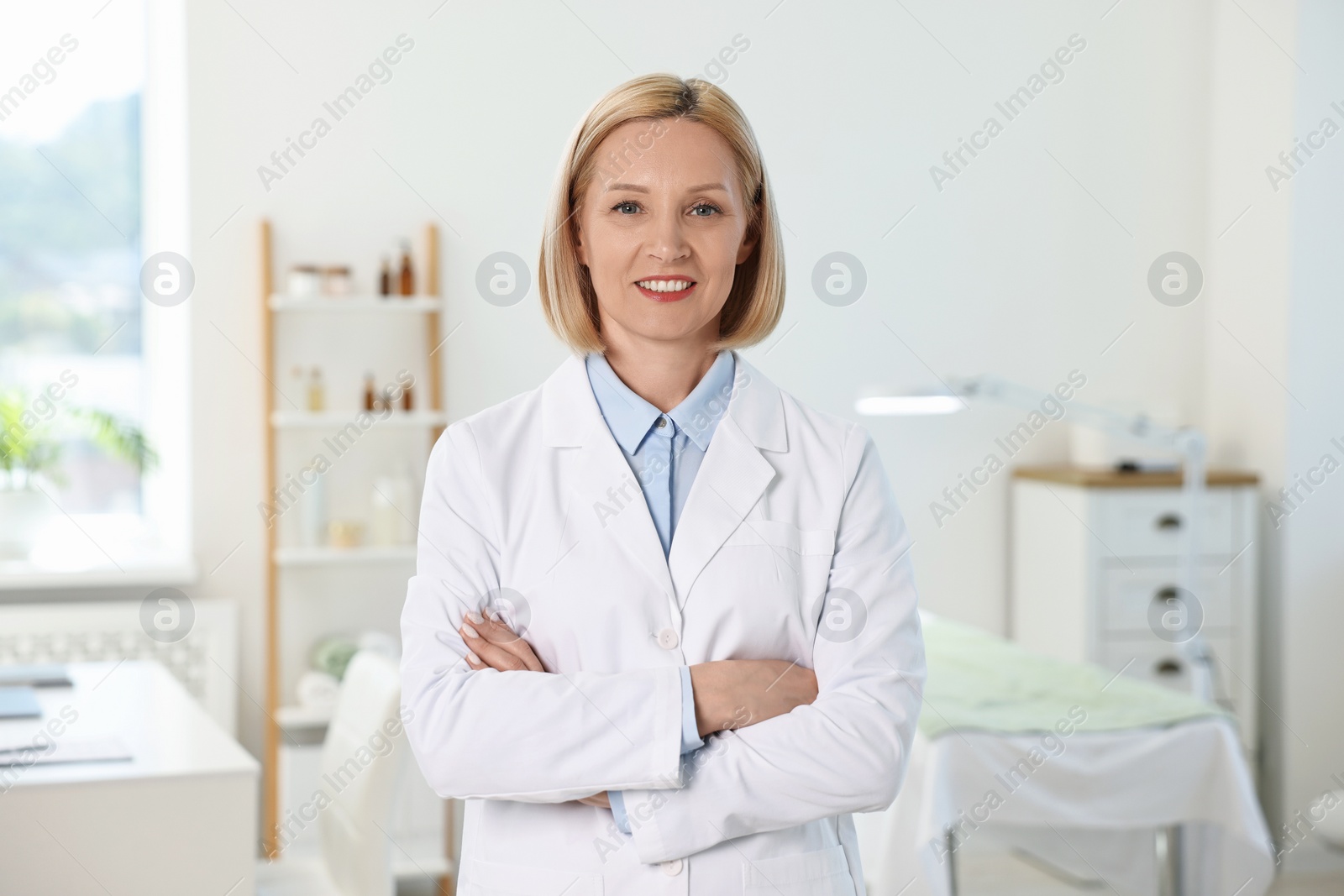 Photo of Portrait of happy dermatologist in modern clinic