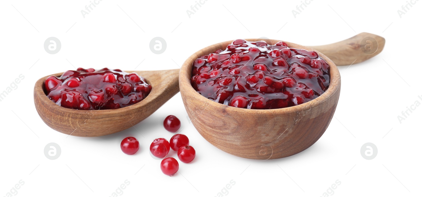 Photo of Tasty cranberry sauce in bowl, spoon and fresh berries isolated on white