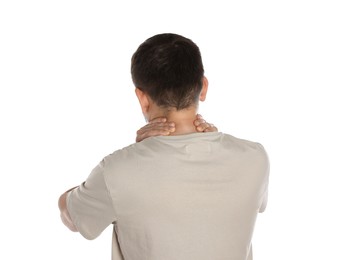 Man suffering from neck pain on white background, back view
