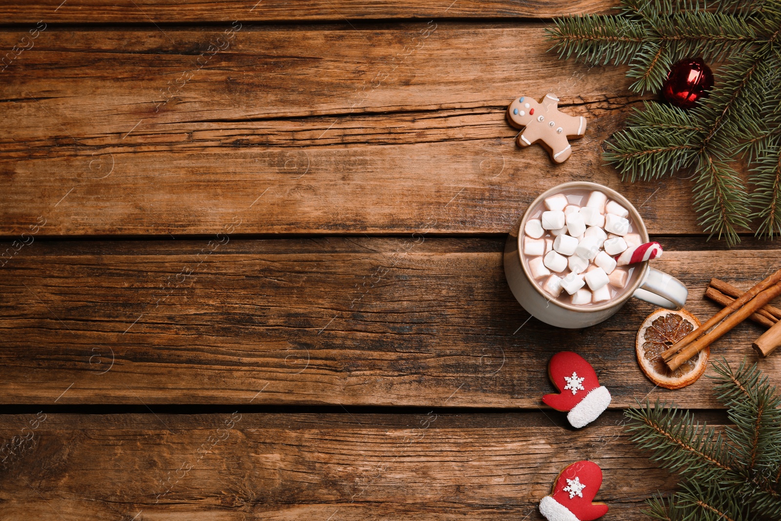 Photo of Flat lay composition of delicious hot chocolate with marshmallows and Christmas decor on wooden table, space for text