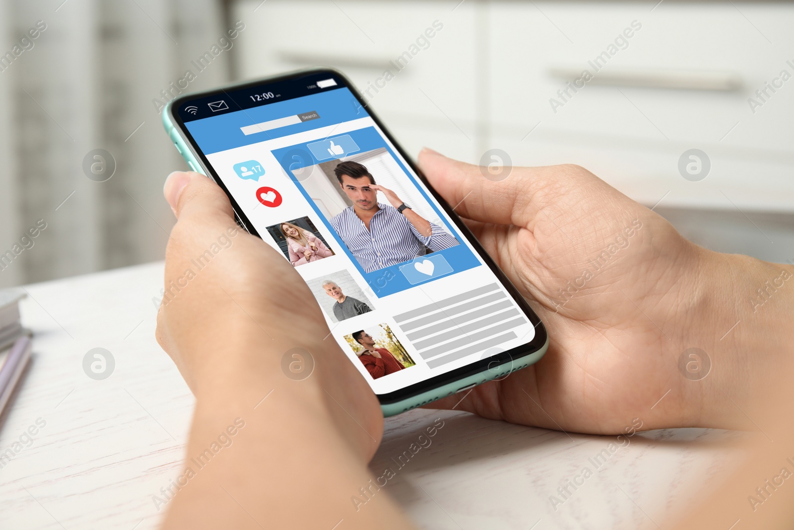 Image of Young woman visiting online dating site via smartphone at table, closeup