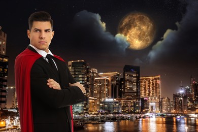 Image of Man wearing superhero costume and beautiful cityscape in night on background