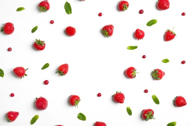 Flat lay composition with with tasty ripe strawberries, cranberries and mint on light background