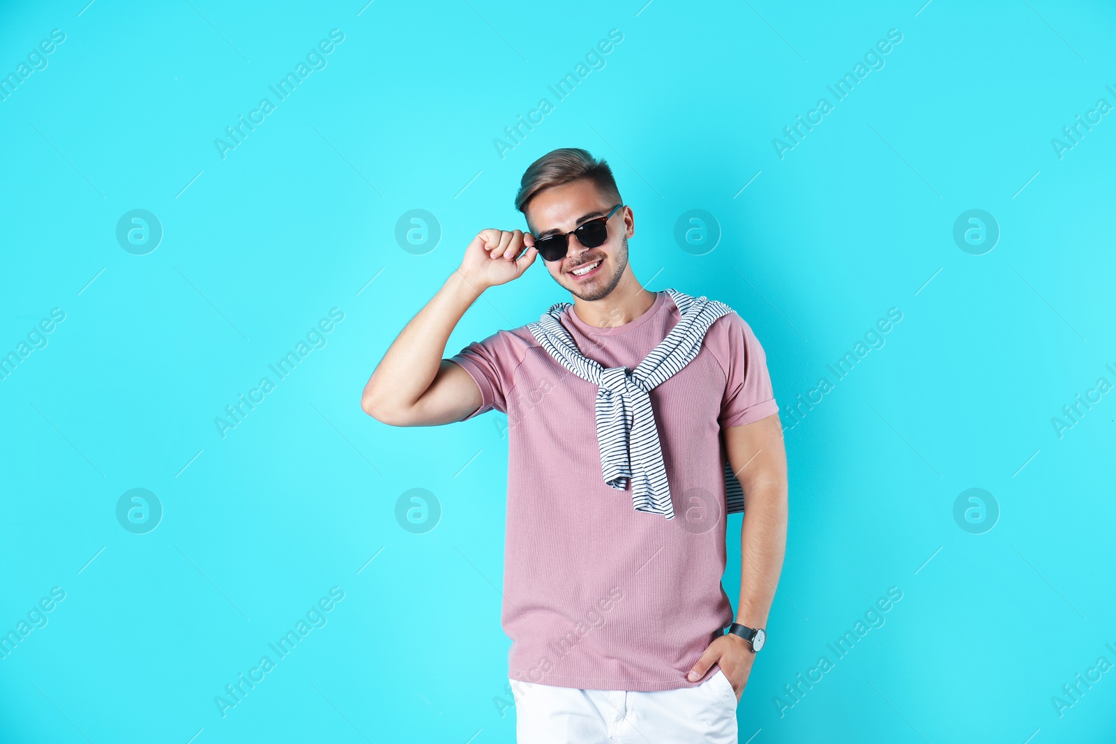 Photo of Young man with trendy hairstyle on color background