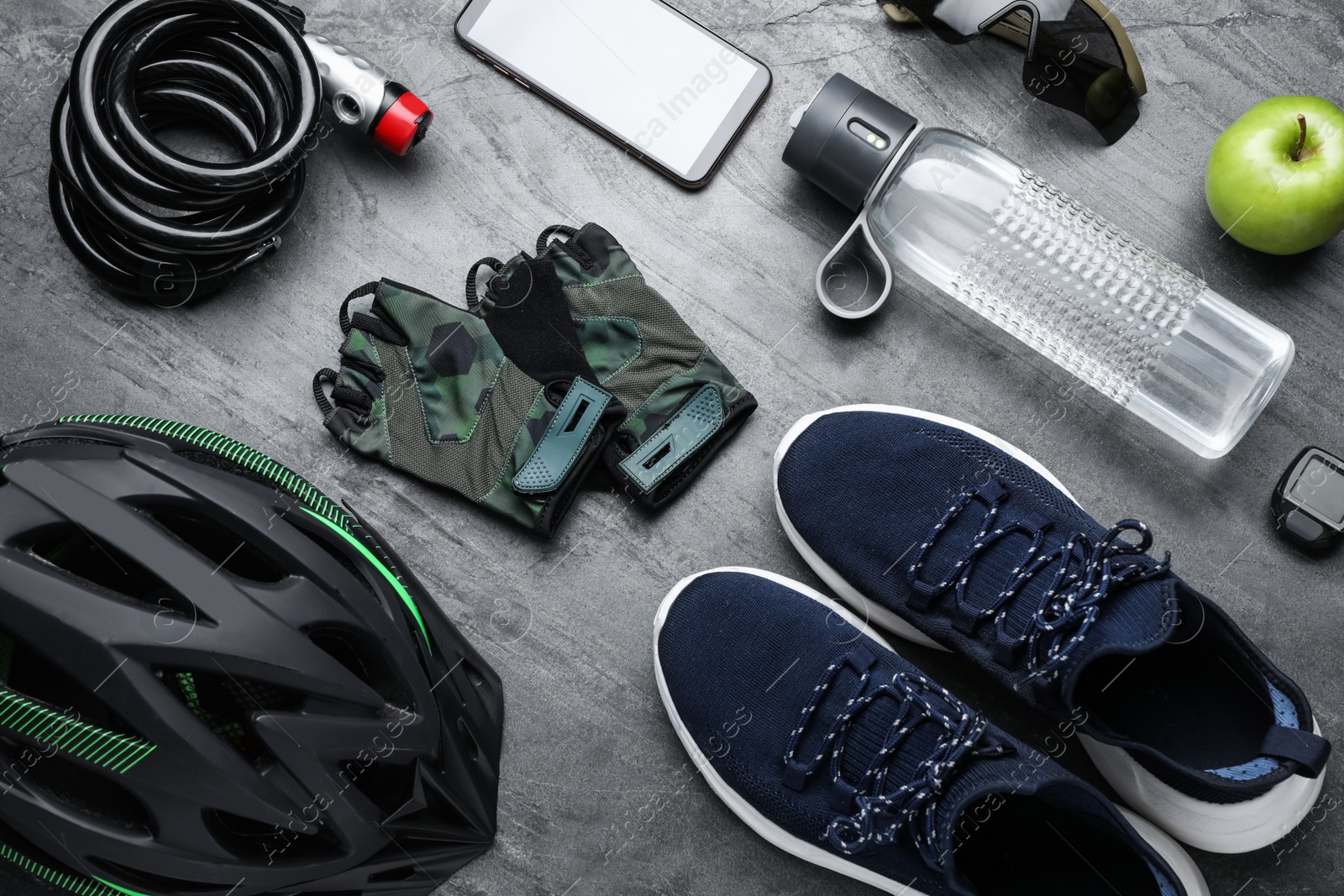 Photo of Flat lay composition with different cycling accessories on grey background