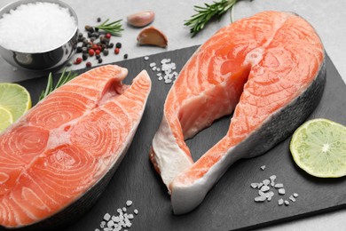 Photo of Fresh salmon and ingredients for marinade on light grey table