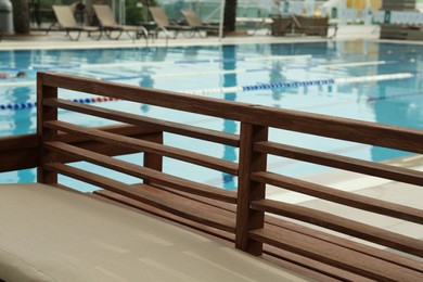 Photo of Wooden bench near swimming pool at luxury resort