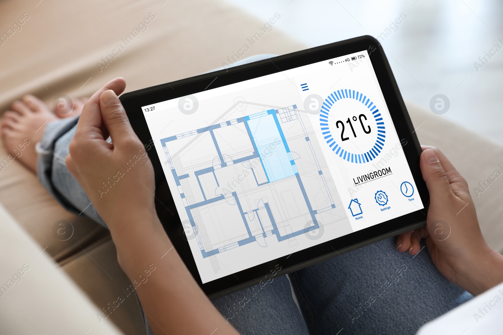 Image of Woman using tablet to control heating system in house, closeup