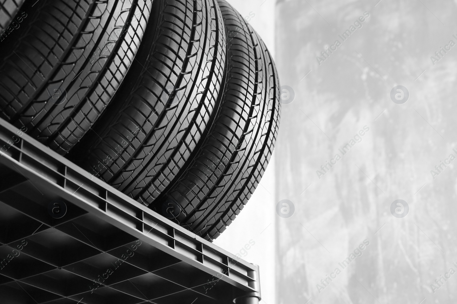 Photo of Car tires on grey background, closeup