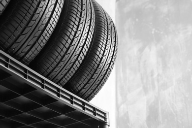 Car tires on grey background, closeup