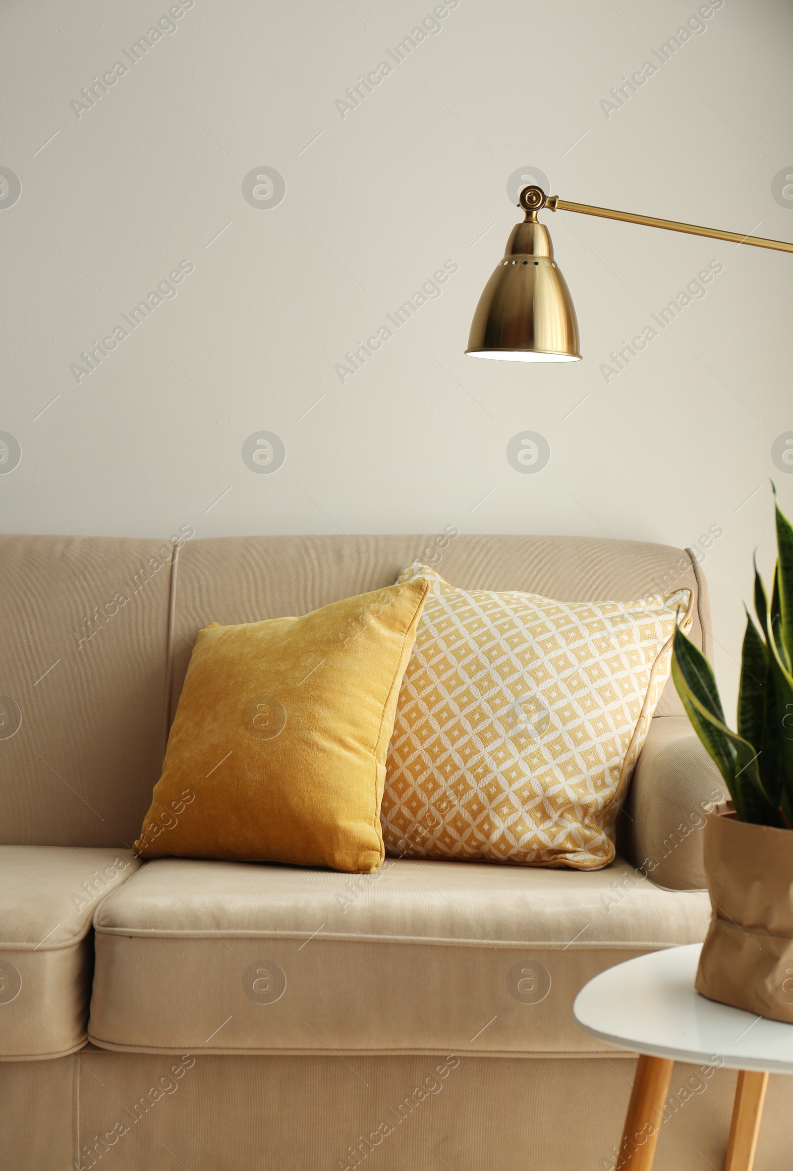 Photo of Comfortable sofa with soft pillows in living room interior