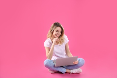 Photo of Woman using laptop for video chat on color background