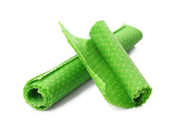 Photo of Rolled beeswax food wraps on white background