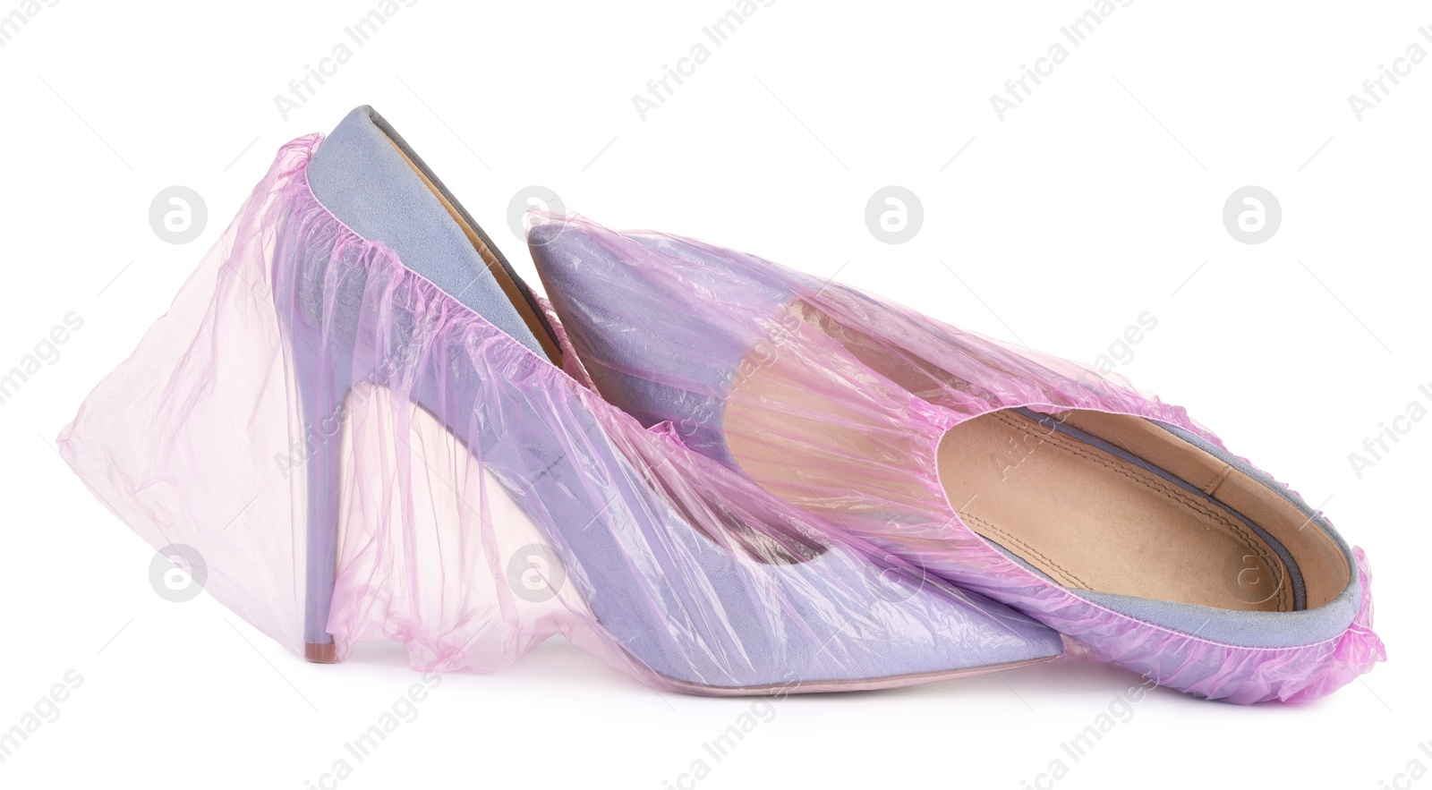 Photo of High heels in pink shoe covers isolated on white