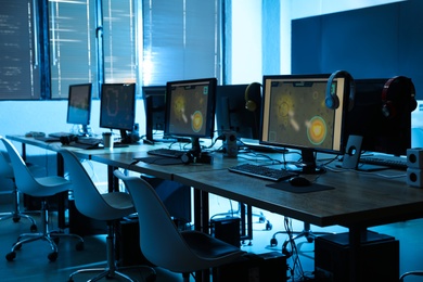 Photo of Internet cafe interior with modern computers. Video game tournament