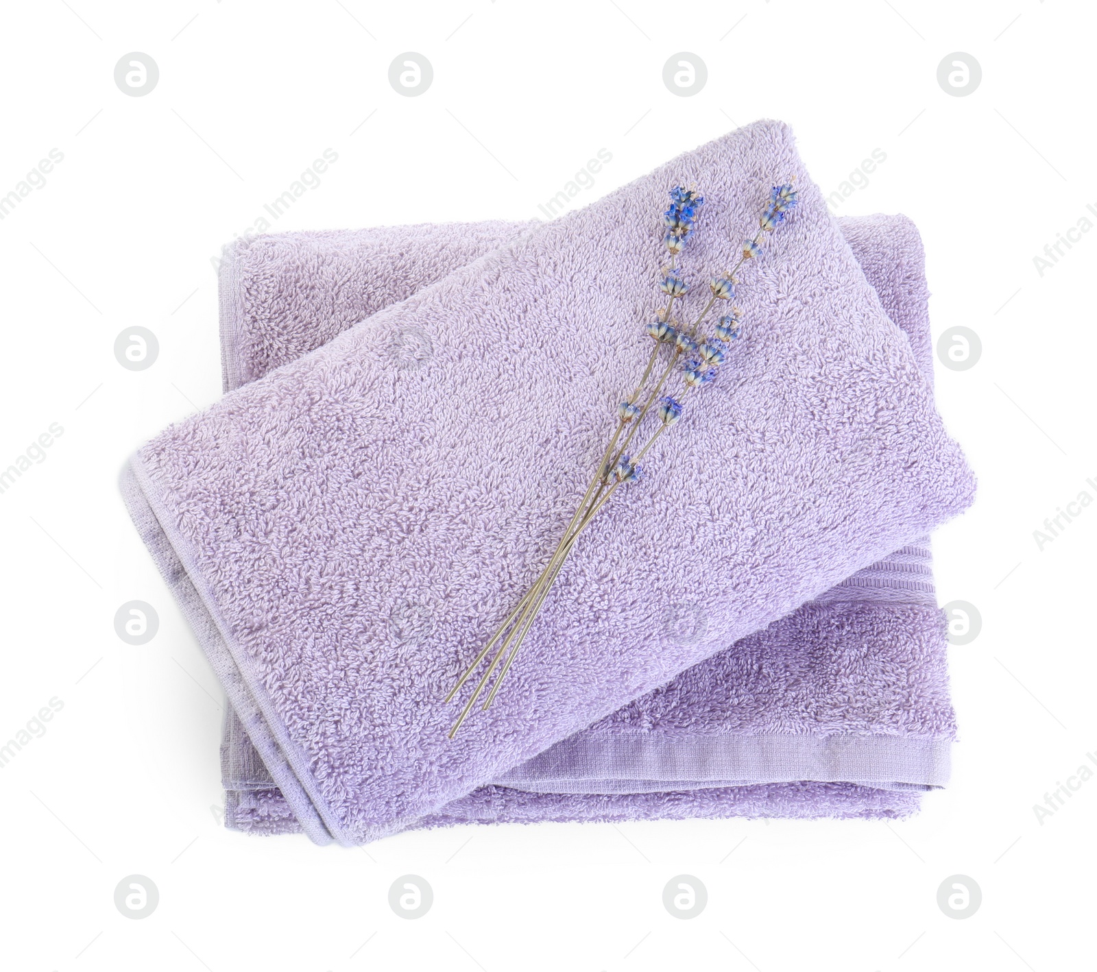 Photo of Violet terry towels and dry lavender isolated on white, top view