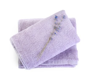 Photo of Violet terry towels and dry lavender isolated on white, top view