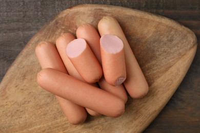 Whole and cut delicious boiled sausages on table, top view