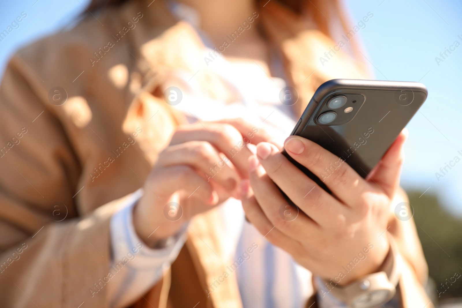 Photo of MYKOLAIV, UKRAINE - MARCH 16, 2020: Woman holding iPhone 11 Black outdoors, closeup