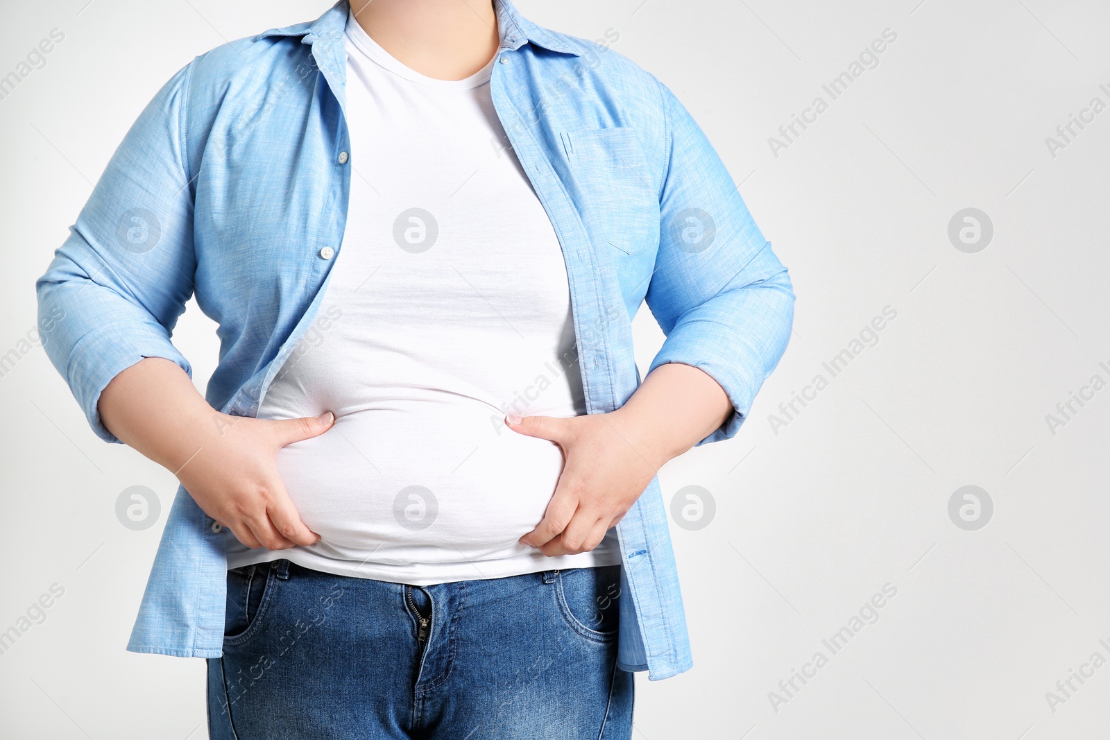 Photo of Overweight woman on light background