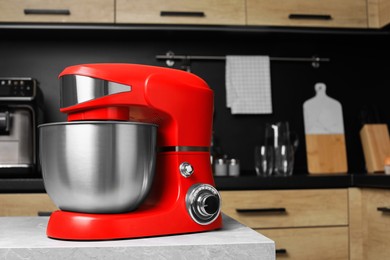 Modern stand mixer on table in kitchen, space for text. Home appliance