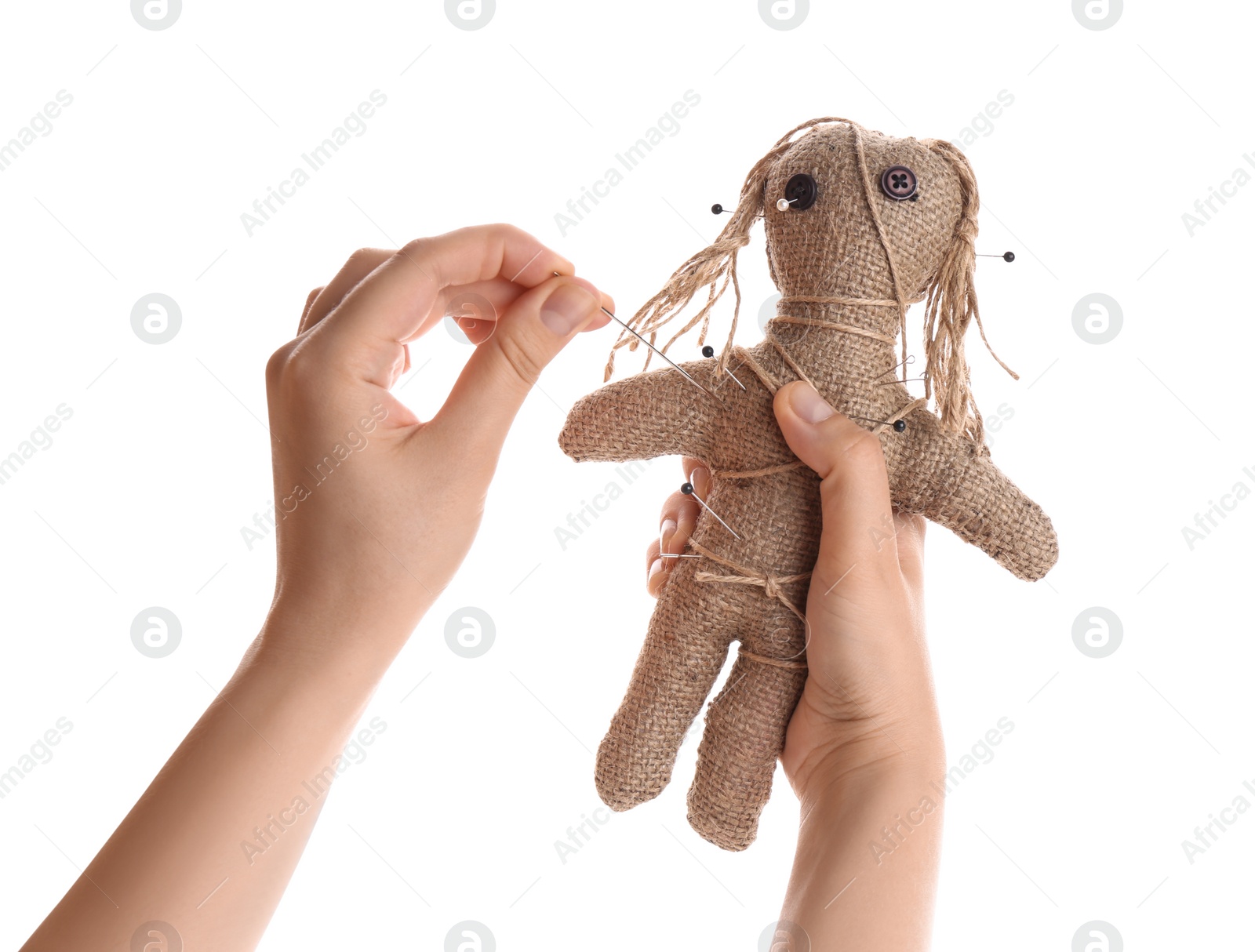 Photo of Woman stabbing voodoo doll with pin on white background, closeup. Curse ceremony