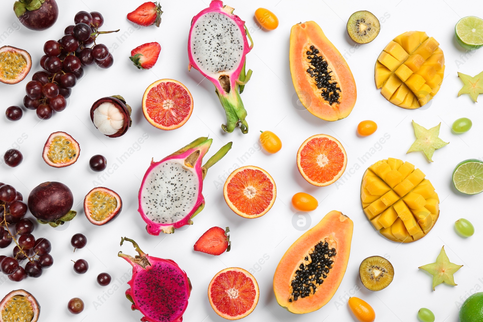 Photo of Many different delicious exotic fruits on white background, flat lay