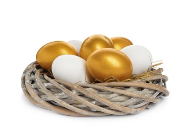 Photo of Nest with golden and ordinary chicken eggs on white background