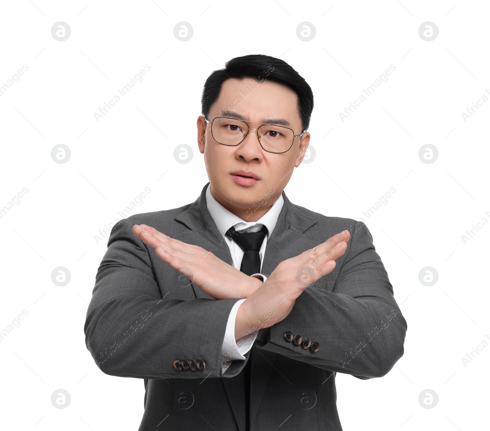 Photo of Angry businessman in suit posing on white background