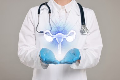 Image of Doctor and illustration of female reproductive system on grey background, closeup