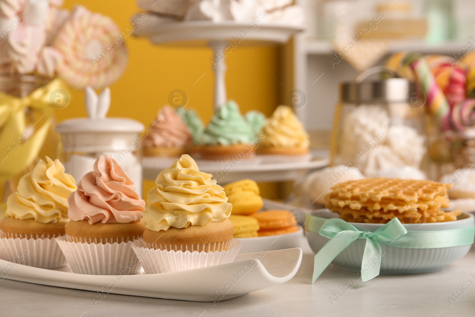 Photo of Tasty cupcakes and other sweets on table. Candy bar, closeup view