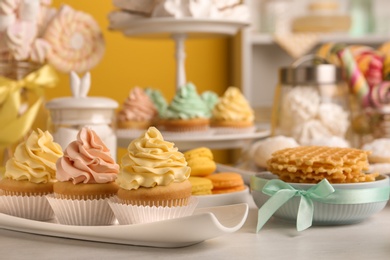 Tasty cupcakes and other sweets on table. Candy bar, closeup view
