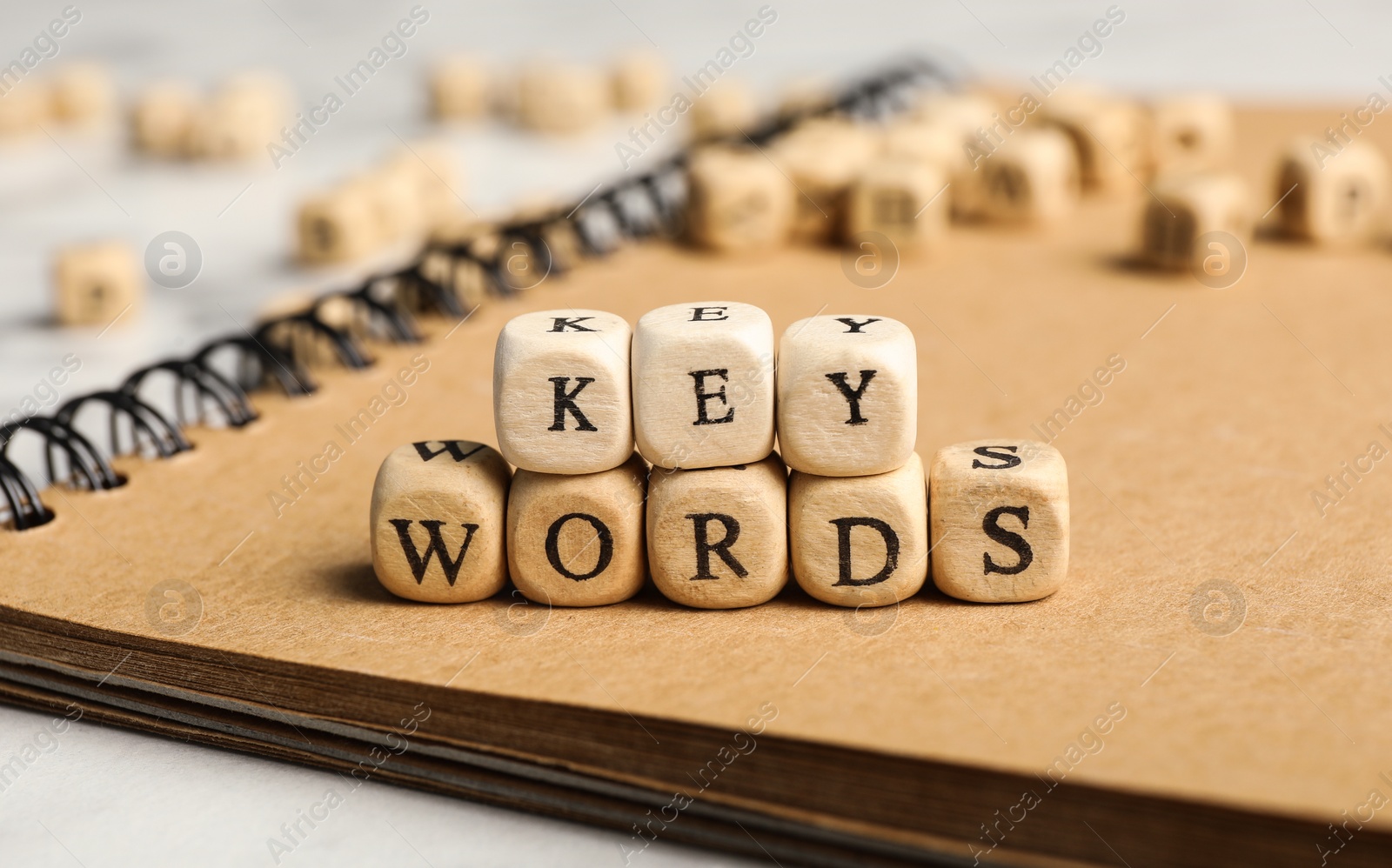 Photo of Beads with word KEYWORDS on notebook, closeup