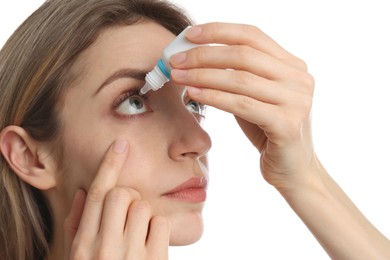Photo of Young woman using eye drops on white background, closeup