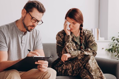 Psychologist working with female military officer in office