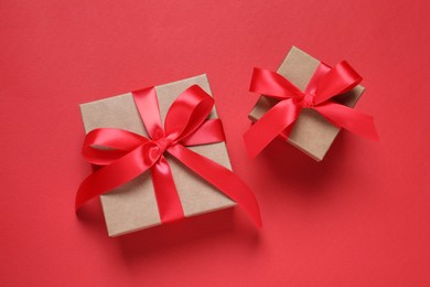 Photo of Beautiful gift boxes on red background, flat lay