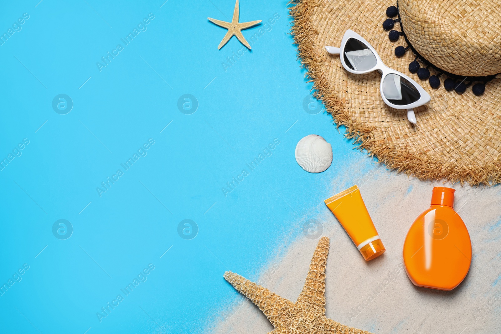 Photo of Flat lay composition with stylish beach accessories on light blue background, space for text