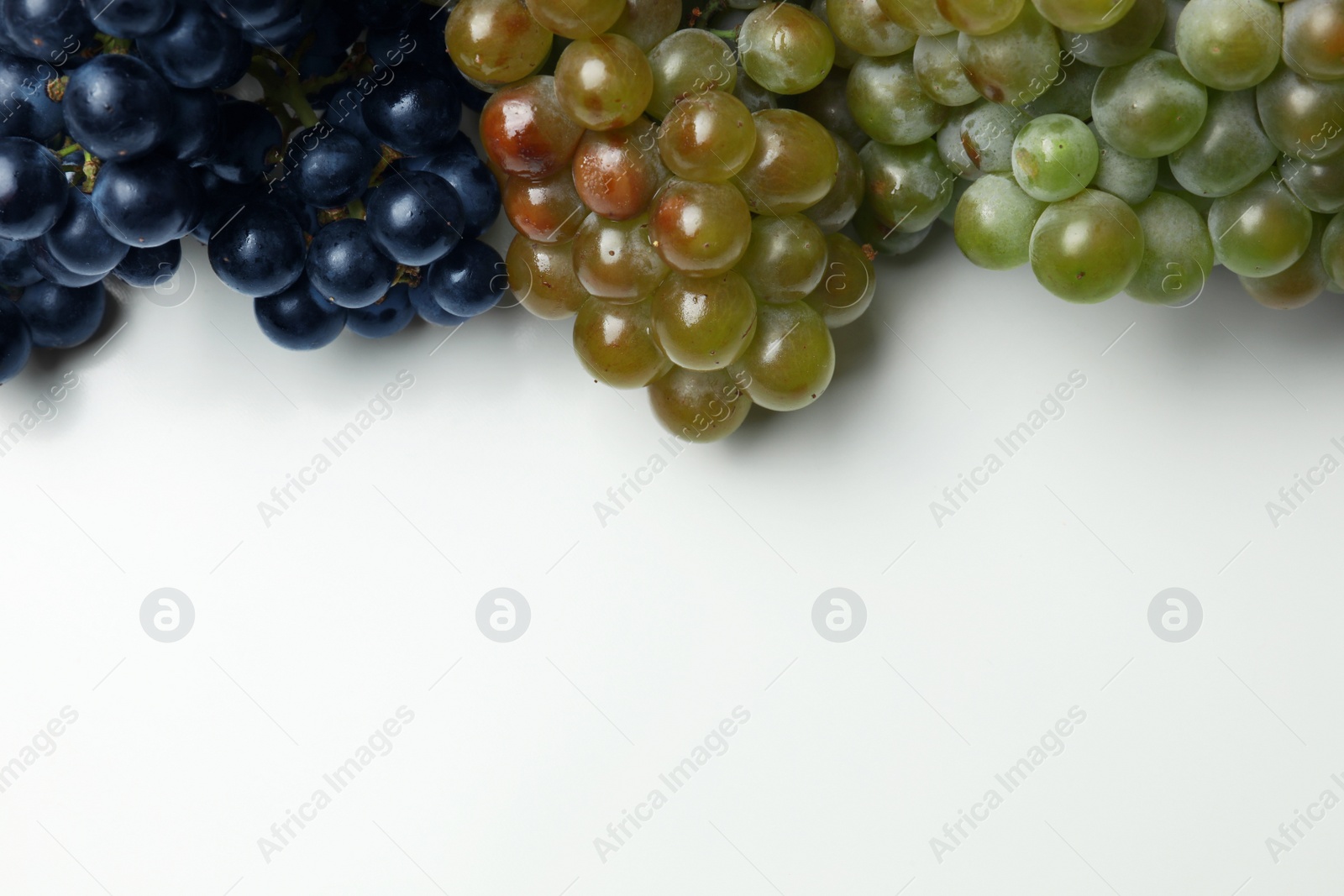 Photo of Fresh ripe juicy grapes on white background, top view