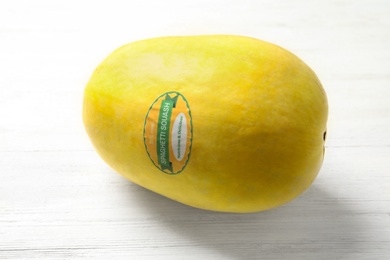 Whole ripe spaghetti squash on wooden background