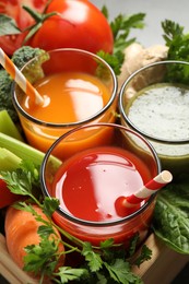 Photo of Delicious vegetable juices and fresh ingredients, closeup view