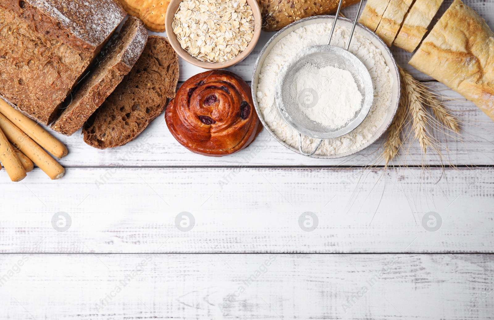 Photo of Different gluten free products on white wooden table, flat lay. Space for text