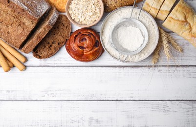 Photo of Different gluten free products on white wooden table, flat lay. Space for text